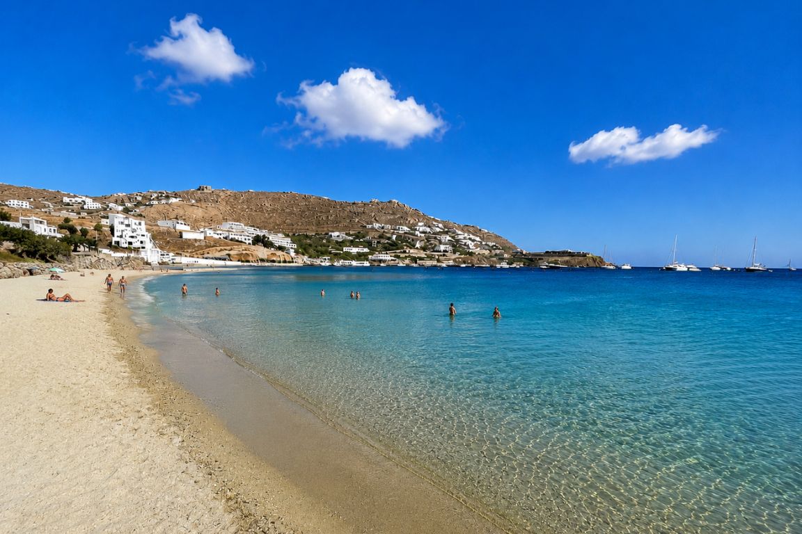 Travelers swimming and relaxing at Ornos Beach with turquoise Aegean Sea waters during a Mykonos Tours adventure