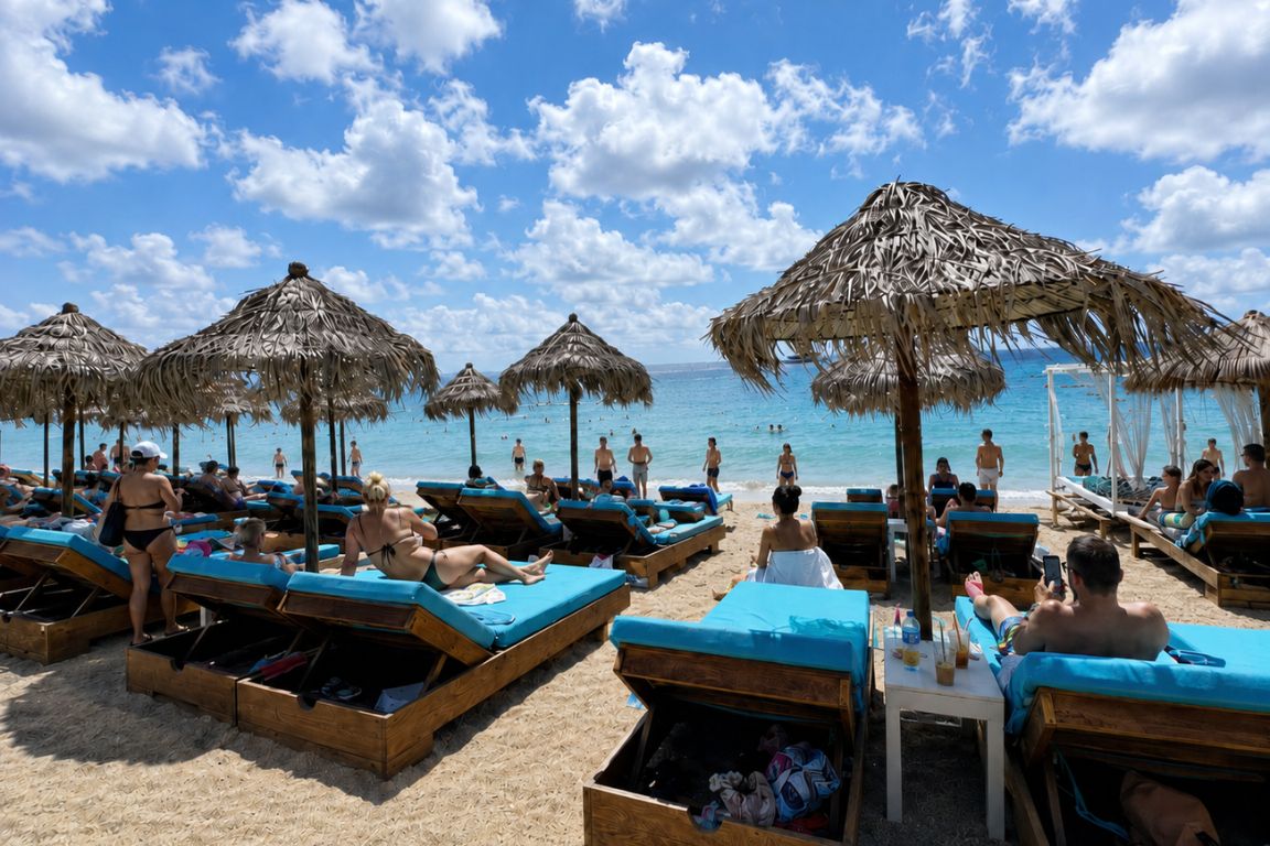Visitors relaxing on sun loungers at Paradise Beach Club in Mykonos during a beach experience with Mykonos Tours